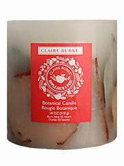 Featuring hand-arranged botanicals enveloping a center display of leafy greens, cinnamon sticks, and vibrant apple slices. The botanical candle is packed with the delightful aroma of Claire Burke's Applejack & Peel® scen